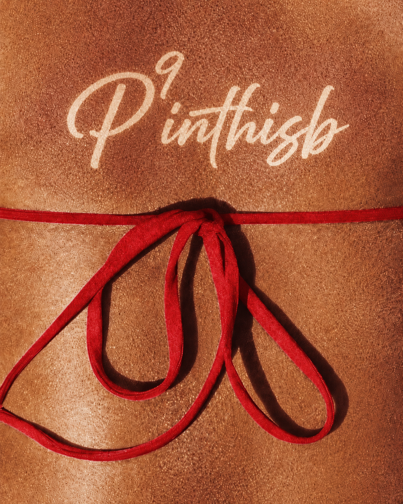 A close-up of a woman's back showcasing a tan line with the word 'P9inthisb'. 