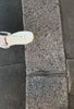 cool video of a person laying a cute Spanish phone case on the floor while tying laces.