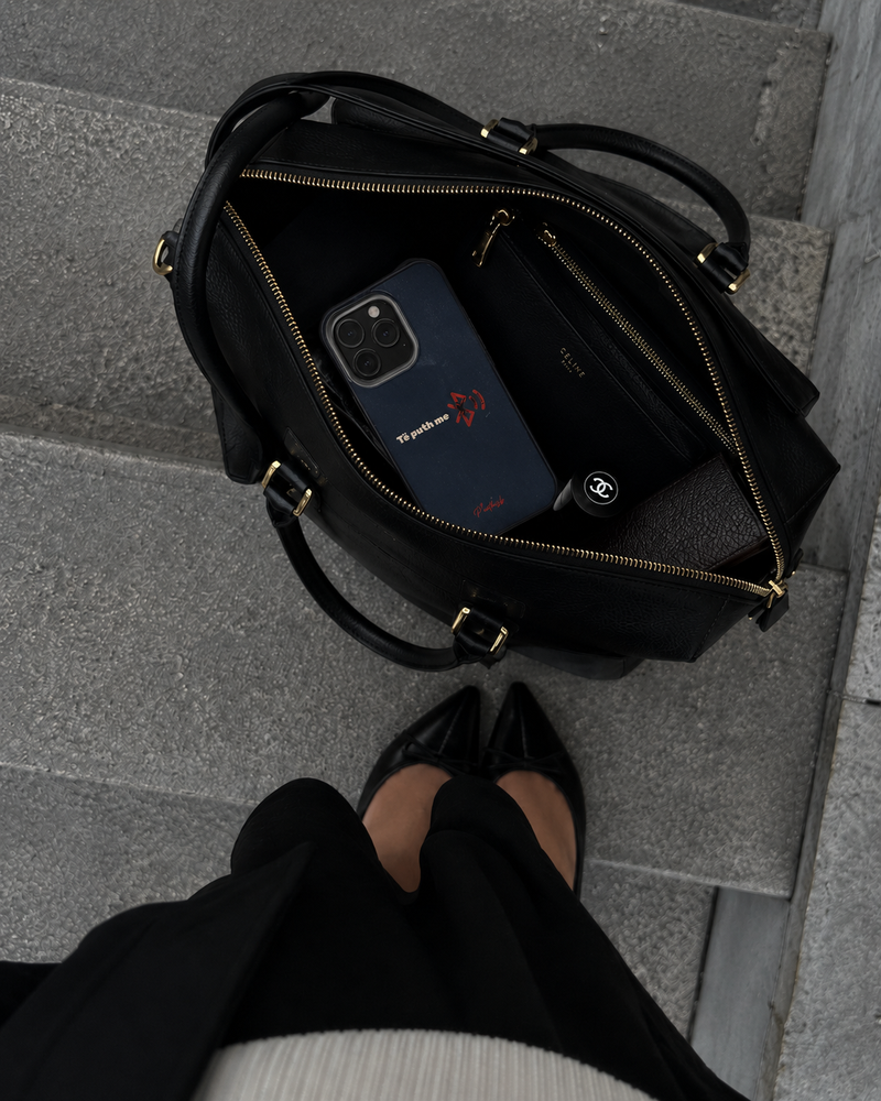 a cool albanian meme case inside a woman's bag